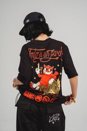 Camiseta Todo es un Parche CHILL oversize negra — algodón peruano 250gr con diablillo cartoon y lettering script en serigrafía naranja, streetwear hecho en Colombia
