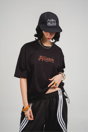 Camiseta Todo es un Parche CHILL oversize negra — algodón peruano 250gr con diablillo cartoon y lettering script en serigrafía naranja, streetwear hecho en Colombia