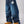 Jeans baggy CHILL azul washed — denim con bordes deshilachados curvos y bordado tribal, streetwear hecho en Colombia
