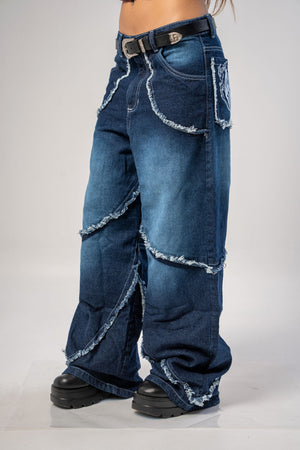 Jeans baggy CHILL azul washed — denim con bordes deshilachados curvos y bordado tribal, streetwear hecho en Colombia