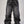Jeans baggy CHILL negro washed — denim con bordes deshilachados curvos y bordado tribal, streetwear hecho en Colombia