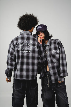 Leñadora Chill world wide negra boxy fit manga larga unisex — camisa a cuadros con lettering script en espalda y CHL en pecho en serigrafía, streetwear hecho en Colombia