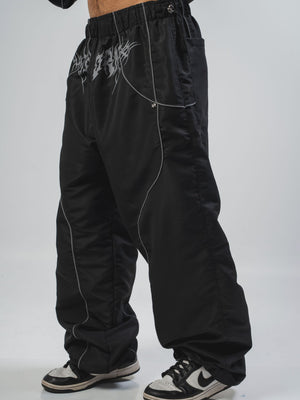 Parachute Reborn CHILL negro — pantalón baggy antifluido con detalles reflectivos y estampado tribal serigrafía, streetwear hecho en Colombia