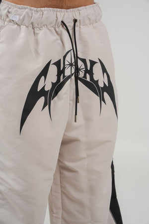 Parachute Track CHILL Crudo — pantalón baggy antifluido con estampado tribal, streetwear hecho en Colombia